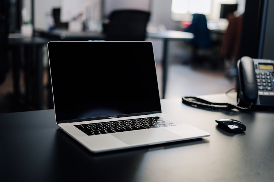 Office desk with a laptop and business desk phone